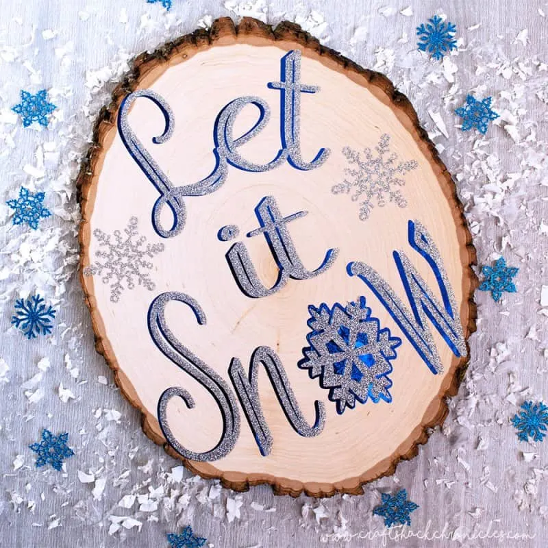 wooden slice sign with words let it snow