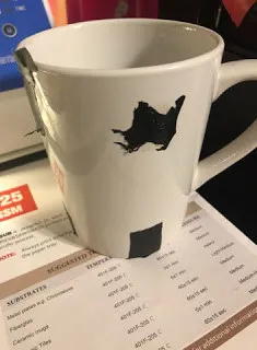 white mug with black tape