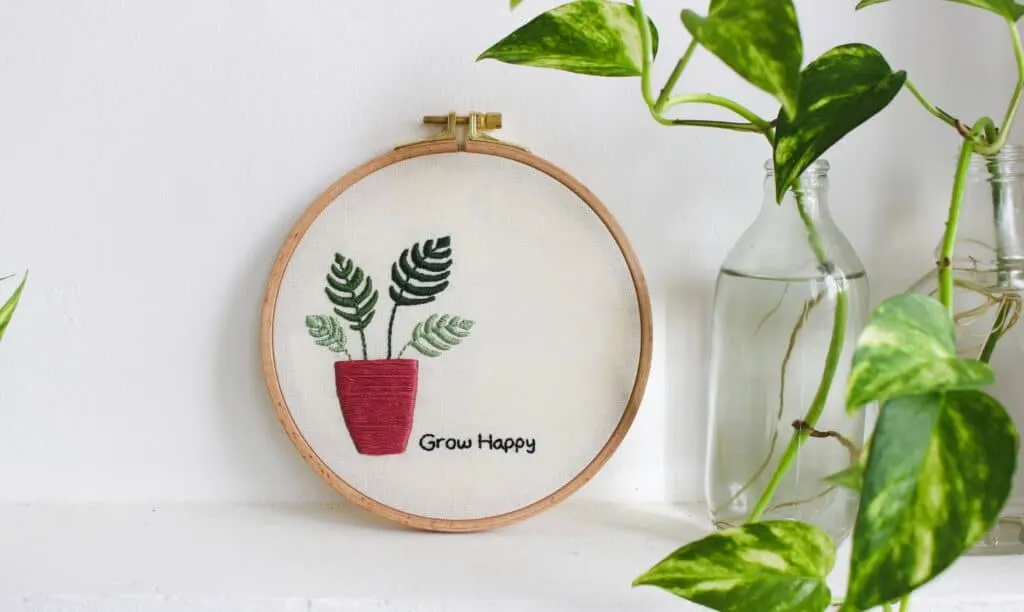 plant in pot on embroidery hoop