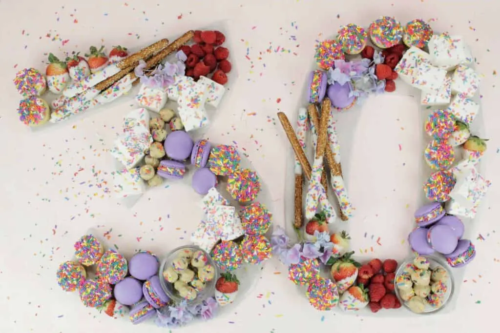 Birthday charcuterie board with sweet and salty snacks in the shape of the number 30