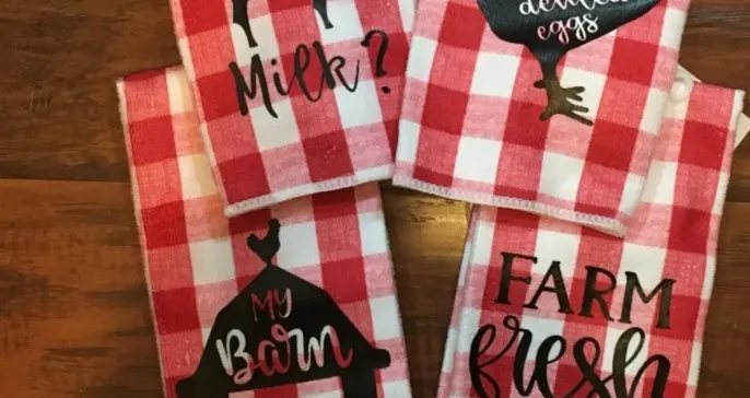 red buffalo plaid kitchen towels with farm animals and funny sayings on them.