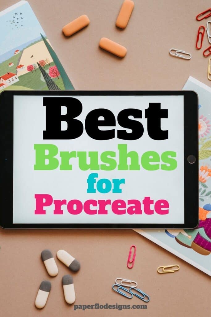 ipad on desk surrounded by illustrated artwork