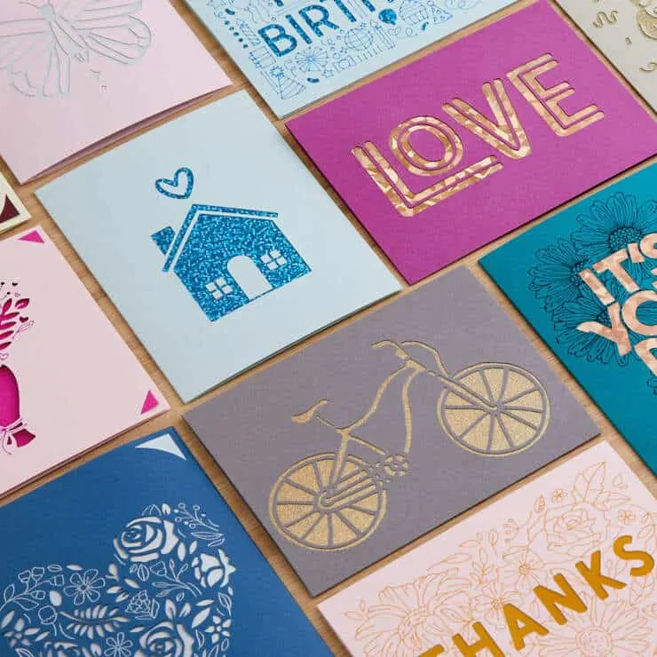 cut out cards with bicycles, a house and words laid out on a table top