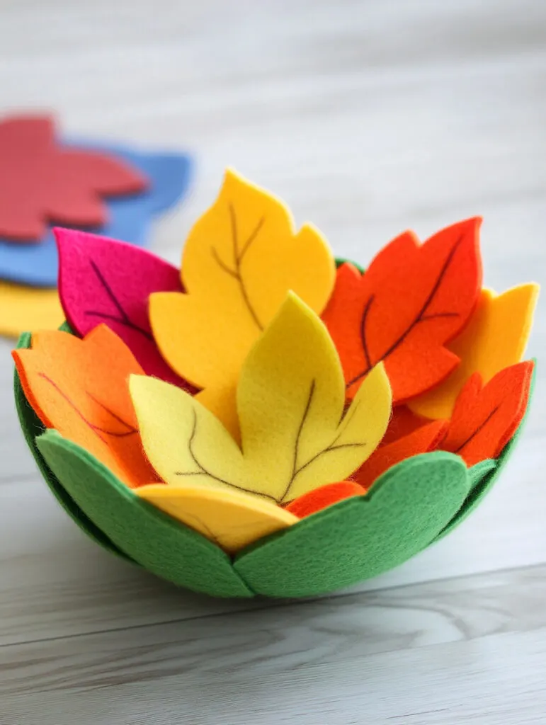 A colorful felt leaf bowl made out of leaf shapes..