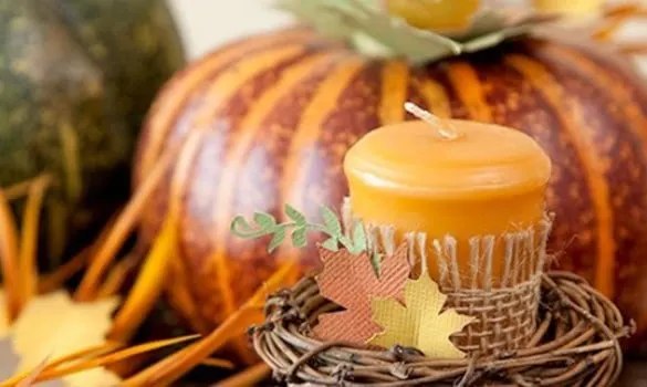 fall leaves centerpiece candle wrapped in burlap and a fall leaf sitting in front of a pumpkin