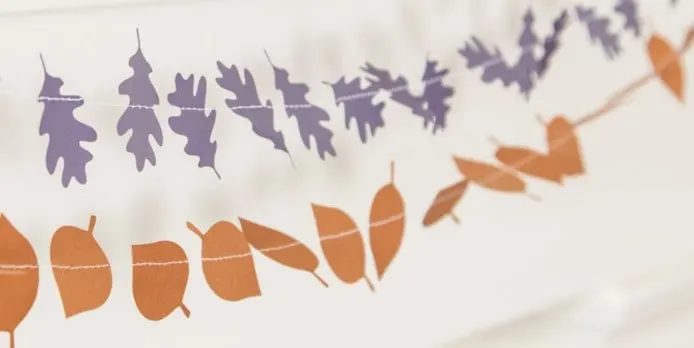 autumn garland made of a set above of purple leaves and a set below of orange leaves