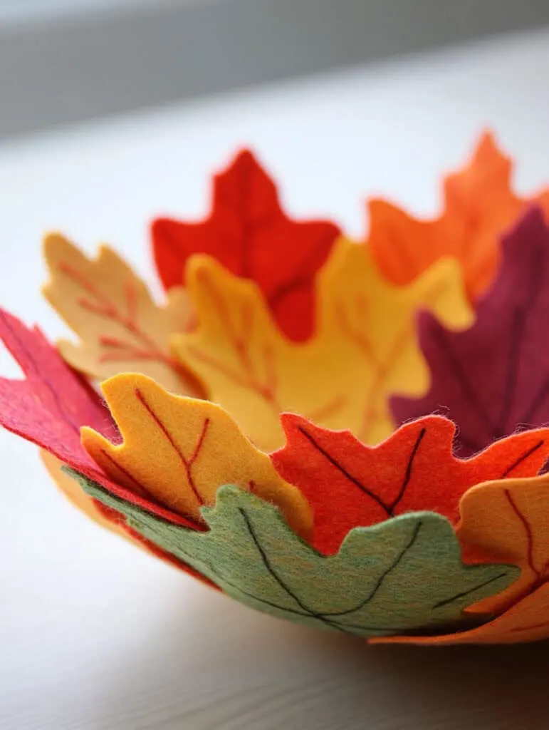A colorful felt leaf bowl made out of leaf shapes..