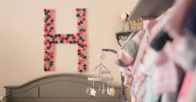 monogram letter H made out of paper flowers on a wall