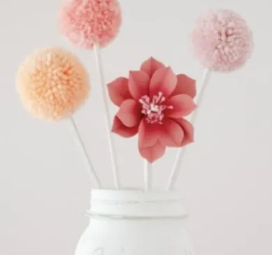 poinsettia and pom pom bouquet in a vase