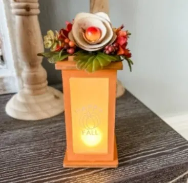 pumpkin lantern with flowers on top