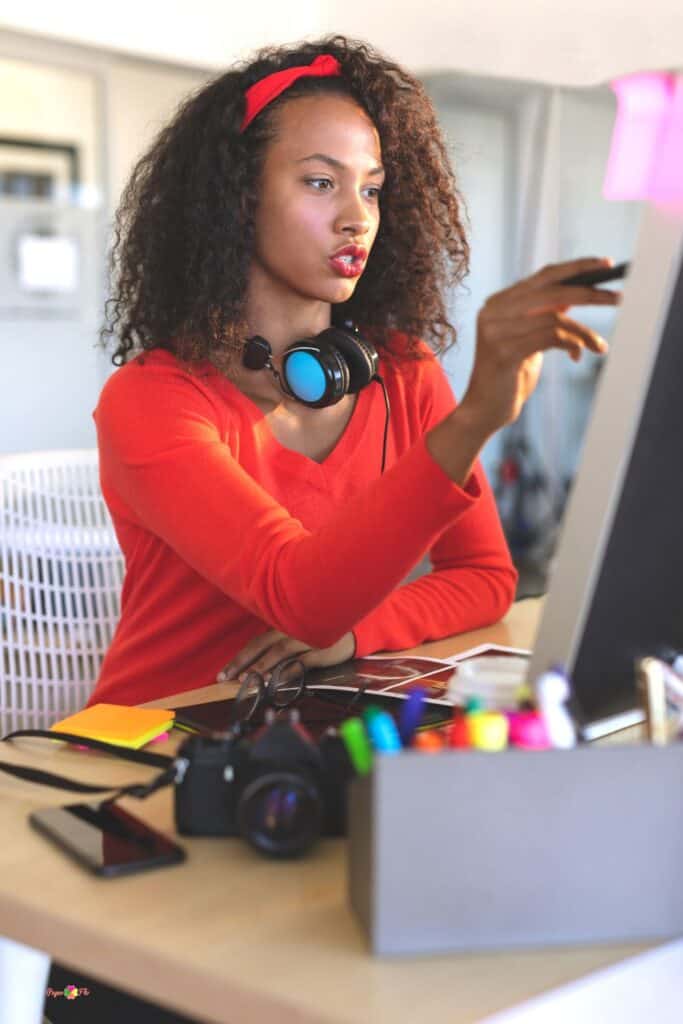 woman sitting at a desk and using a computer to make vector files.