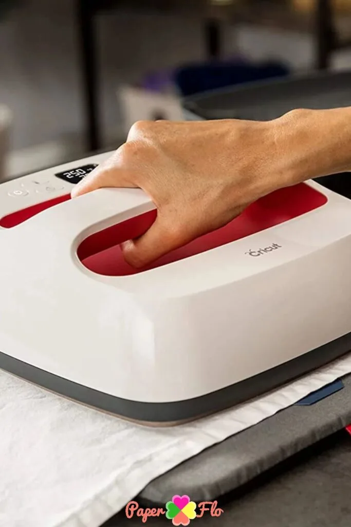 Person using a Cricut Press with a press cloth