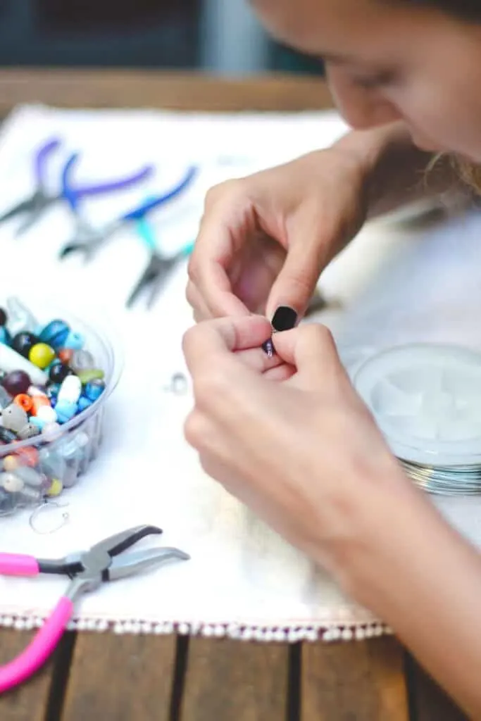 woman making jewelry
