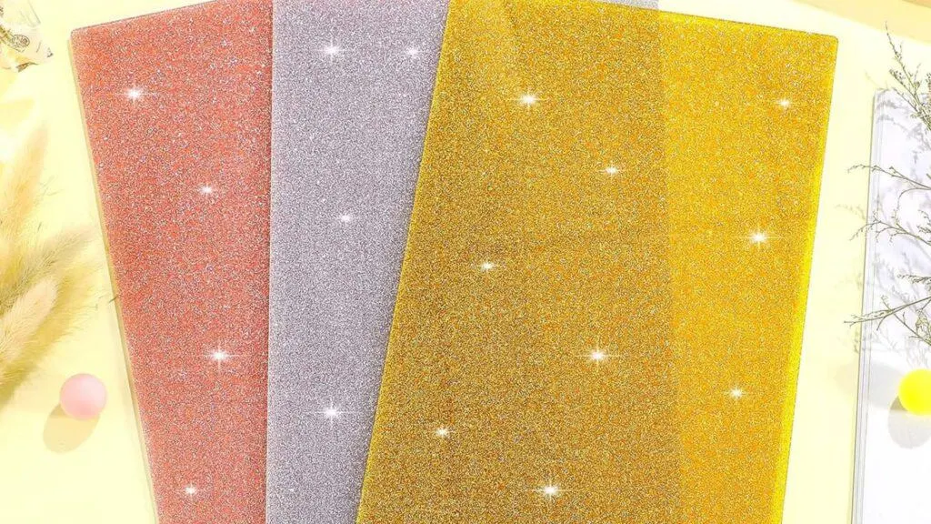 3 pieces of glitter acrylic sheets for laser cutting that are stacked on top of each other and spread out like a fan.