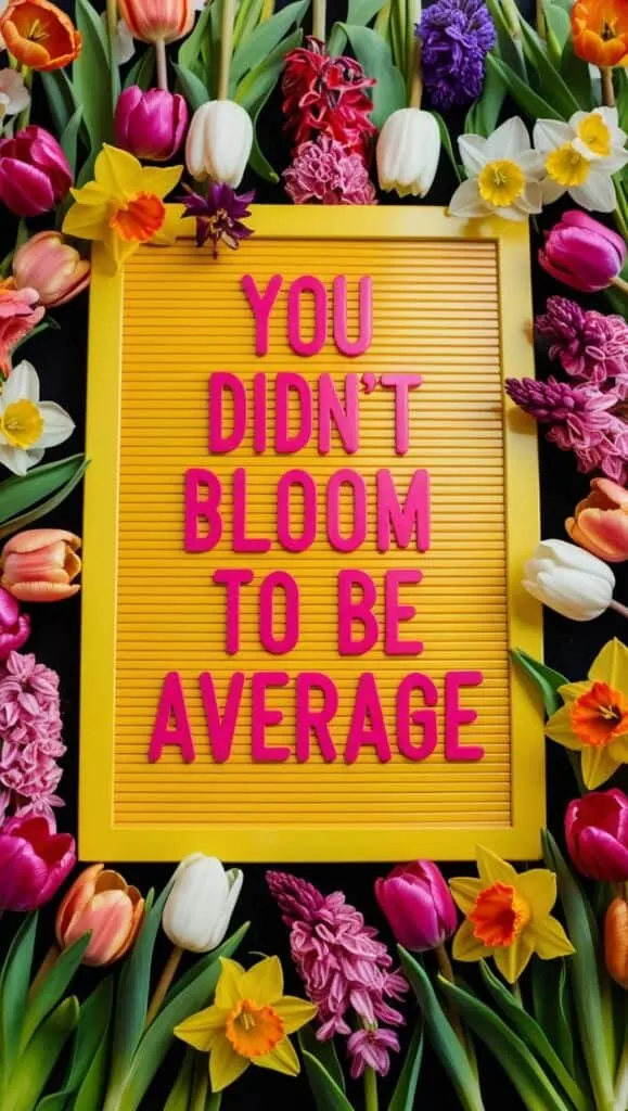 A colorful letter board surrounded by blooming flowers, featuring spring-related quotes.