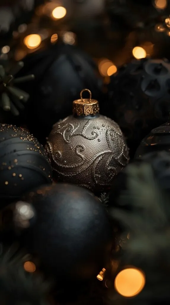 Looking for black Christmas tree decorating ideas that feel modern and classy? This close-up of textured metallic and matte black ornaments shows how easy it is to create a moody Christmas tree style without overspending. Try mixing luxe finishes like brushed metal, matte black, and subtle sparkle. Perfect inspiration for anyone wanting a bold, modern Christmas tree look this season.